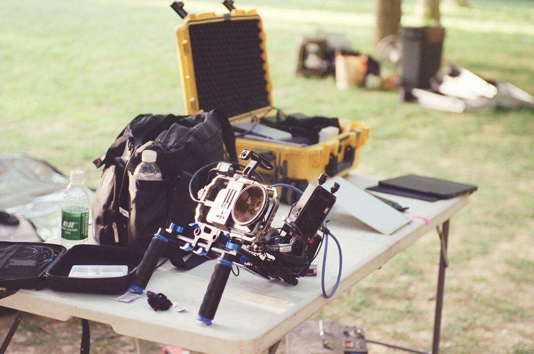 Professional camera operator framing a live broadcast shot in a field setup
